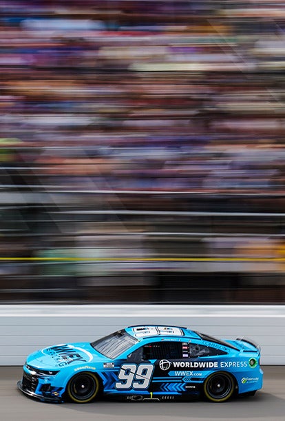 A bright blue race car emblazoned with the number 99 and Worldwide Express branding zooms down the track. As it blurs past, its like a hero module in motion, capturing attention and leaving the crowd in awe of its speed.