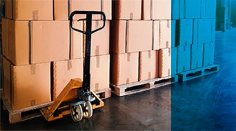 Stack of shipments boxes on wooden pallets at interior warehouse storage.